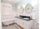 Elegant bathroom with double vanity, clawfoot tub, and patterned floor at 808 E Worthington Ave, Charlotte, NC 28203