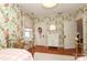 Charming bedroom with floral wallpaper, twin beds, and a dresser at 808 E Worthington Ave, Charlotte, NC 28203