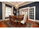 Dark-blue dining room features a wooden table and chandelier at 808 E Worthington Ave, Charlotte, NC 28203