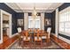 Dark-blue dining room with wooden table, chandelier, and hardwood floors at 808 E Worthington Ave, Charlotte, NC 28203