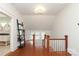 Upstairs hallway with hardwood floors and built-in shelving at 808 E Worthington Ave, Charlotte, NC 28203