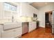 Modern kitchen with white cabinets, stainless steel appliances, and hardwood floors at 808 E Worthington Ave, Charlotte, NC 28203