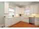 Modern kitchen with white cabinets, a farmhouse sink, and hardwood floors at 808 E Worthington Ave, Charlotte, NC 28203