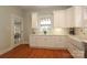 Modern kitchen with white cabinets, farmhouse sink, and hardwood floors at 808 E Worthington Ave, Charlotte, NC 28203