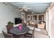 Relaxing screened porch with seating area, dining table, and TV at 808 E Worthington Ave, Charlotte, NC 28203