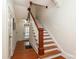 Classic wooden staircase with white railings and hardwood floors at 808 E Worthington Ave, Charlotte, NC 28203