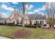 Inviting exterior of charming ranch home with stone accents and landscaped yard at 874 Ledgestone Ct, Tega Cay, SC 29708