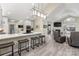 Modern kitchen with white cabinets, breakfast bar, and stainless steel appliances at 874 Ledgestone Ct, Fort Mill, SC 29708