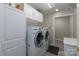 Laundry room with washer, dryer, and ample cabinet space at 874 Ledgestone Ct, Fort Mill, SC 29708