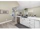 Modern kitchen with white cabinets, stainless steel appliances, and quartz countertops at 874 Ledgestone Ct, Tega Cay, SC 29708