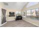 Sunroom with hardwood floors, piano, and large windows at 874 Ledgestone Ct, Tega Cay, SC 29708