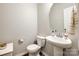 Small bathroom with pedestal sink, toilet and octagonal mirror at 970 Bunker Trce, Rock Hill, SC 29730