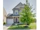 Two-story house with gray siding, stone accents, and a tree in the front yard at 970 Bunker Trce, Rock Hill, SC 29730