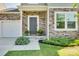 Inviting front entrance with stone facade, dark door, and potted plants at 970 Bunker Trce, Rock Hill, SC 29730