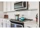 Kitchen features gas cooktop, microwave, and white subway tile backsplash at 970 Bunker Trce, Rock Hill, SC 29730