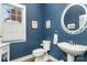 Stylish powder room with a pedestal sink and dark blue walls at 9929 Allyson Park Dr, Charlotte, NC 28277