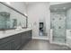 Elegant bathroom with double vanities, a large shower, and marble tile at 9929 Allyson Park Dr, Charlotte, NC 28277