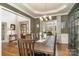 Elegant dining room with hardwood floors, large windows, and a chandelier at 9929 Allyson Park Dr, Charlotte, NC 28277