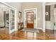 Bright and spacious foyer with hardwood floors and French doors at 9929 Allyson Park Dr, Charlotte, NC 28277