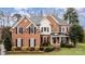 Brick two-story house with a landscaped yard and large windows at 9929 Allyson Park Dr, Charlotte, NC 28277