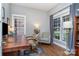 Home office with hardwood floors, large windows, and built-in shelving at 9929 Allyson Park Dr, Charlotte, NC 28277