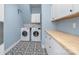 Bright laundry room with washer, dryer, and built-in cabinets at 9929 Allyson Park Dr, Charlotte, NC 28277