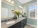 Double vanity bathroom with light green walls and granite countertop at 100 S Centurion Ln, Mount Holly, NC 28120