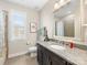 Bathroom boasts granite countertop and large mirror at 100 S Centurion Ln, Mount Holly, NC 28120