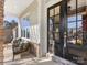 Relaxing front porch with two wicker chairs, a black door, and stone accents at 100 S Centurion Ln, Mount Holly, NC 28120