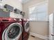 Convenient laundry room with washer, dryer, and ample shelving at 100 S Centurion Ln, Mount Holly, NC 28120