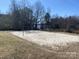 Sand volleyball court with net and lake view at 100 S Centurion Ln, Mount Holly, NC 28120