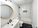 Bathroom featuring a black and white tile design, a decorative sink, and a bathtub with a shower at 1003 W 4Th Ave, Gastonia, NC 28052