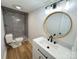 Bathroom featuring a shower, a decorative sink and vanity, and modern lighting fixtures at 1003 W 4Th Ave, Gastonia, NC 28052