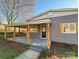 Charming single-Gathering home featuring a covered front porch with rustic wood columns and gray shingle siding at 1003 W 4Th Ave, Gastonia, NC 28052