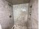 Modern tiled shower with built-in shelving and a rainfall shower head at 1003 W 4Th Ave, Gastonia, NC 28052