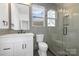 Modern bathroom with a white vanity, gray tile, and a glass shower at 10517 S Hampton Dr, Charlotte, NC 28227