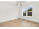 Light-filled bedroom with hardwood floors and large window at 10517 S Hampton Dr, Charlotte, NC 28227