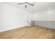 Spacious bonus room with hardwood floors and a staircase at 10517 S Hampton Dr, Charlotte, NC 28227