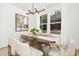 Elegant dining room with a wood table, neutral chairs, and large windows at 10517 S Hampton Dr, Charlotte, NC 28227