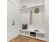 White entryway with built-in bench, cubbies, and hooks for coats at 10517 S Hampton Dr, Charlotte, NC 28227