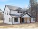 Two-story white house with a gray roof and wooden posts at 10517 S Hampton Dr, Charlotte, NC 28227