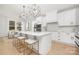 Bright kitchen boasts white cabinets, an expansive island, and high-end finishes at 10517 S Hampton Dr, Charlotte, NC 28227