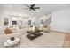 Open concept living room with a modern aesthetic, featuring a fireplace and kitchen views at 10517 S Hampton Dr, Charlotte, NC 28227