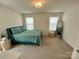 Comfortable bedroom with a queen-size bed and mirror at 11005 Woodland Creek Way, Charlotte, NC 28262