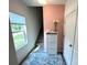 Bright entryway with stairs, shoe storage, and pink accent wall at 11005 Woodland Creek Way, Charlotte, NC 28262