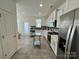 Modern kitchen with stainless steel appliances and gray tile floor at 11005 Woodland Creek Way, Charlotte, NC 28262