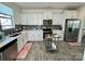 Modern kitchen with stainless steel appliances and gray tile floor at 11005 Woodland Creek Way, Charlotte, NC 28262