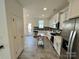 Modern kitchen with stainless steel appliances and gray tile floor at 11005 Woodland Creek Way, Charlotte, NC 28262