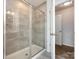 Bathroom with walk-in shower and glass enclosure at 11021 Ogden Ln, Charlotte, NC 28278