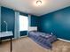 Bedroom with teal walls and a single bed at 11021 Ogden Ln, Charlotte, NC 28278